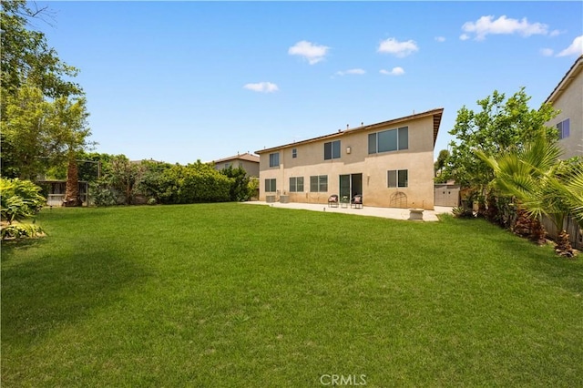 12337 Columbia Ln, Eastvale, CA 91752 - back of house featuring stucco siding, a patio, and a lawn