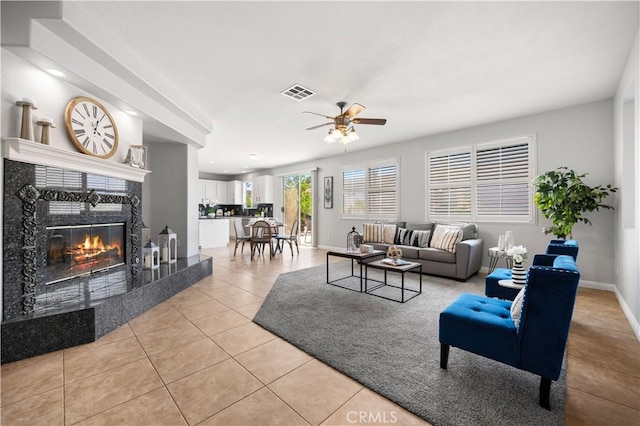 12337 Columbia Ln, Eastvale, CA 91752 - living area featuring ceiling fan, a high end fireplace, and light tile patterned flooring