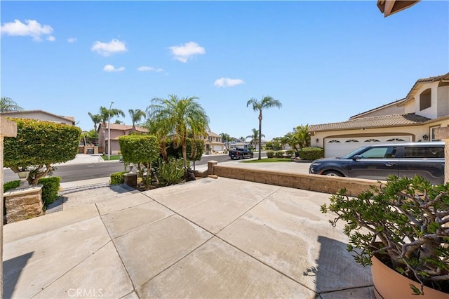 12337 Columbia Ln, Eastvale, CA 91752 - view of patio / terrace with a residential view, an attached garage, and concrete driveway