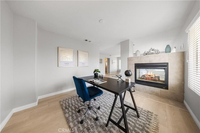 12337 Columbia Ln, Eastvale, CA 91752 - office with light wood-type flooring and a fireplace