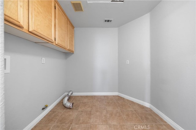 12337 Columbia Ln, Eastvale, CA 91752 - laundry area featuring cabinet space and light tile patterned flooring