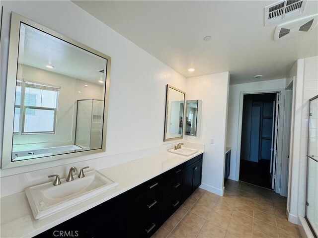 158 Scale, Irvine, CA 92618 - bathroom featuring a stall shower, double vanity, and tile patterned flooring