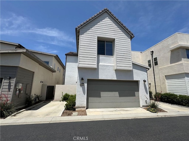 158 Scale, Irvine, CA 92618 - view of front of house with stucco siding, an attached garage, and driveway