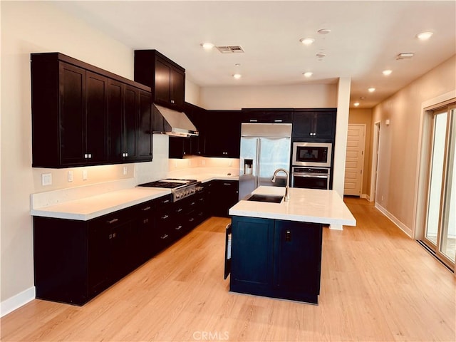 158 Scale, Irvine, CA 92618 - kitchen with under cabinet range hood, built in appliances, light wood-style floors, light countertops, and plenty of natural light