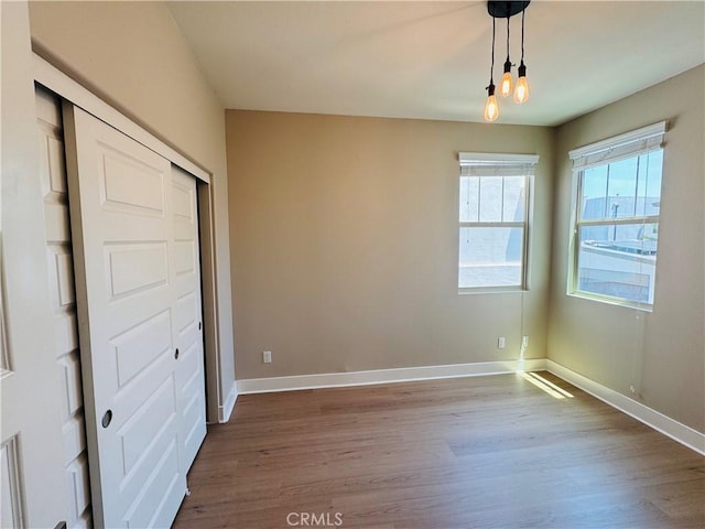 158 Scale, Irvine, CA 92618 - unfurnished bedroom with dark wood-style flooring and a closet