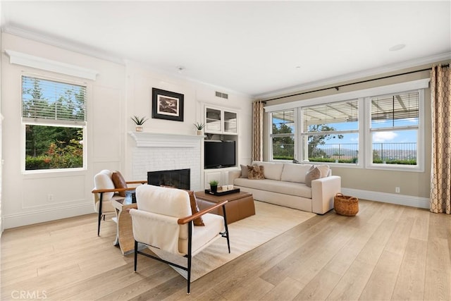 37 Craftsbury Pl, Ladera Ranch, CA 92694 - living area with healthy amount of natural light, light wood-style floors, a brick fireplace, and ornamental molding
