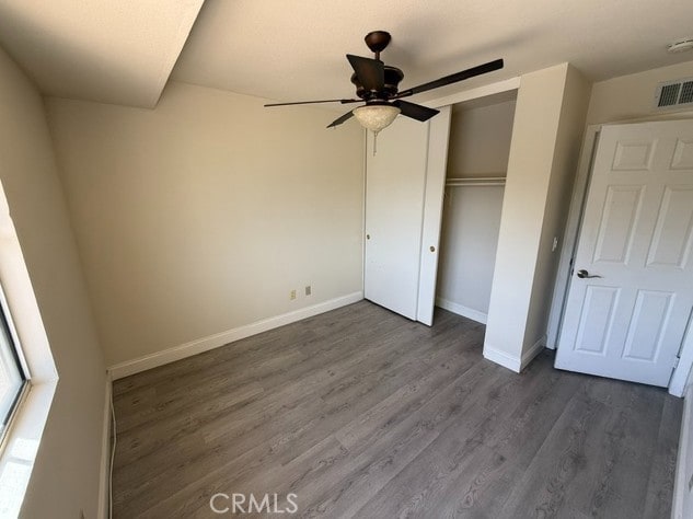 27745 Desert Pl, Castaic, CA 91384 - unfurnished bedroom featuring dark wood-style floors, a closet, and ceiling fan