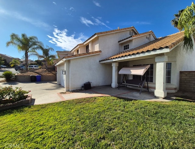 27745 Desert Pl, Castaic, CA 91384 - back of house with a patio, stucco siding, a garage, and a lawn