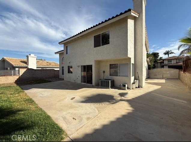 27745 Desert Pl, Castaic, CA 91384 - back of house featuring a patio area, a fenced backyard, stucco siding, and a chimney