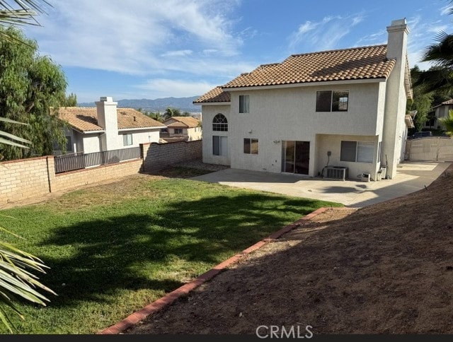 27745 Desert Pl, Castaic, CA 91384 - back of house featuring a tile roof, stucco siding, a fenced backyard, a patio area, and a chimney
