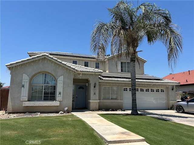 5825 Sky Lakes Ave, Bakersfield, CA 93313 - view of front of home with roof mounted solar panels, stucco siding, concrete driveway, a front lawn, and a tiled roof