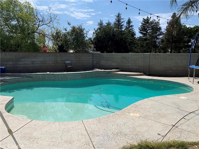 5825 Sky Lakes Ave, Bakersfield, CA 93313 - view of pool featuring a trampoline, a fenced backyard, and a patio