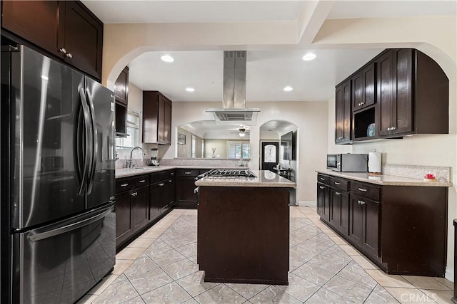 921 N Brand Blvd, San Fernando, CA 91340 - kitchen with stainless steel appliances, island exhaust hood, a peninsula, arched walkways, and recessed lighting