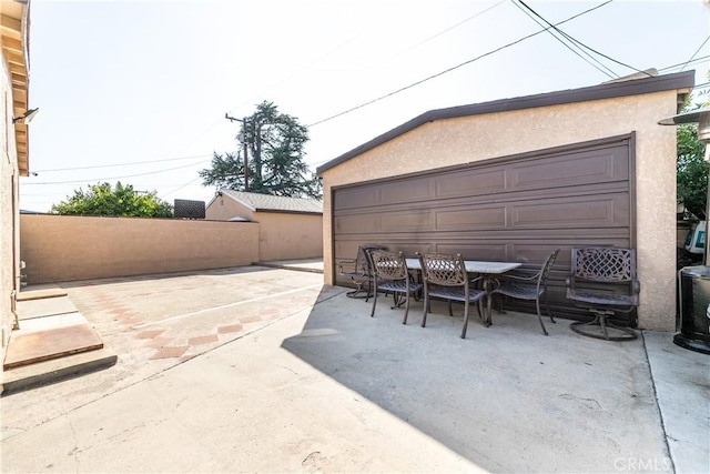921 N Brand Blvd, San Fernando, CA 91340 - view of patio with outdoor dining space and a detached garage
