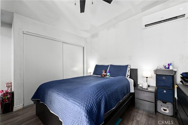 921 N Brand Blvd, San Fernando, CA 91340 - bedroom with an AC wall unit, wood finished floors, a closet, and a ceiling fan