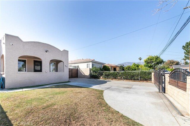 921 N Brand Blvd, San Fernando, CA 91340 - fenced yard with concrete driveway, a patio, and a gate