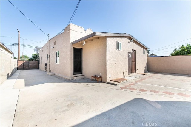 921 N Brand Blvd, San Fernando, CA 91340 - back of house with stucco siding, a fenced backyard, and a patio