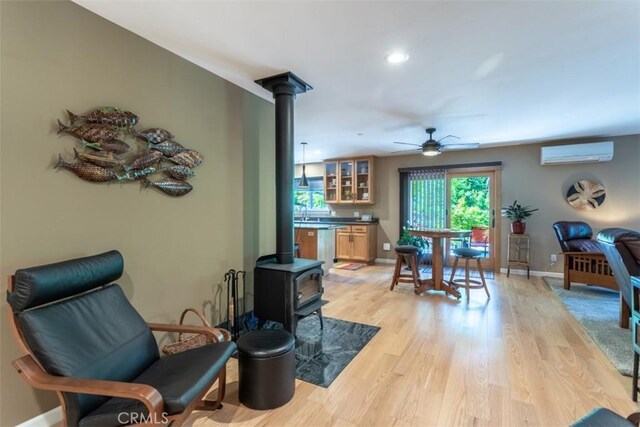 9116 Rocky Rd, Weed, CA 96094 - dining area featuring a wood stove, a wall mounted AC, ceiling fan, baseboards, and recessed lighting