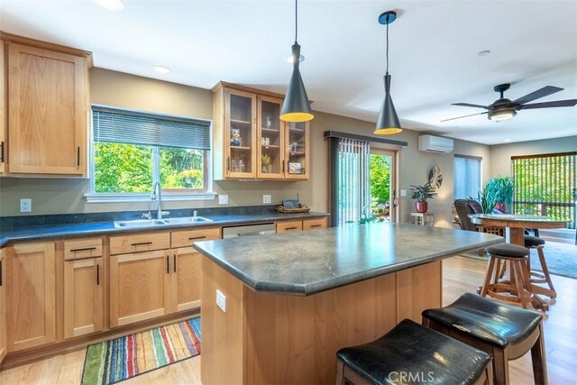 9116 Rocky Rd, Weed, CA 96094 - kitchen featuring a wall mounted air conditioner, a sink, dark countertops, light wood finished floors, and a kitchen island