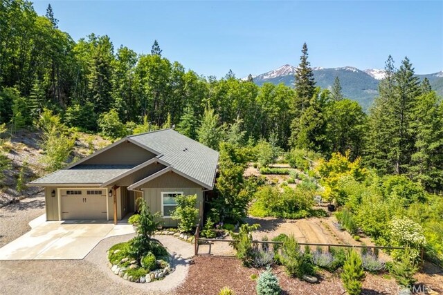 9116 Rocky Rd, Weed, CA 96094 - view of front of home featuring a garage, board and batten siding, driveway, and a mountain view
