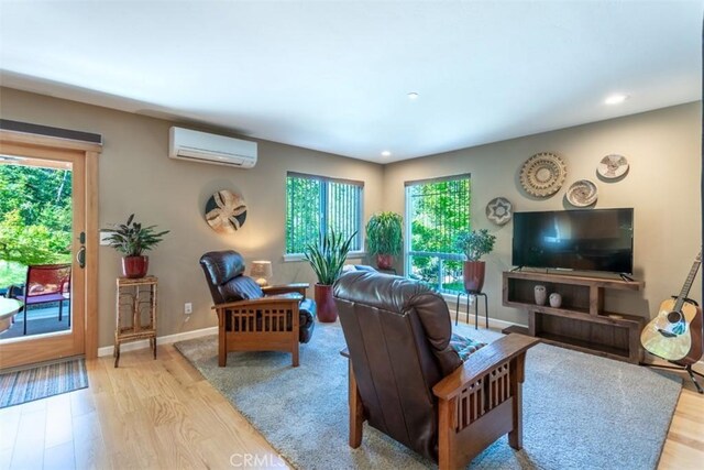 9116 Rocky Rd, Weed, CA 96094 - living area with a wall mounted air conditioner, light wood-style floors, recessed lighting, and baseboards