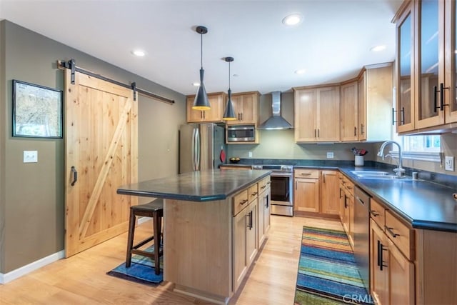 9116 Rocky Rd, Weed, CA 96094 - kitchen featuring appliances with stainless steel finishes, wall chimney exhaust hood, a barn door, dark countertops, and a kitchen bar