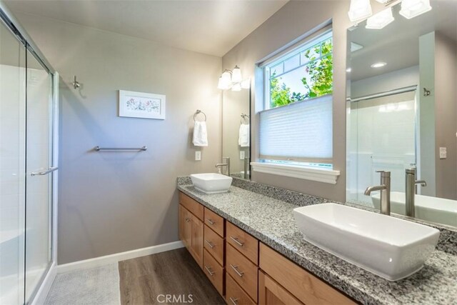 9116 Rocky Rd, Weed, CA 96094 - full bath with double vanity, a shower stall, baseboards, and wood finished floors