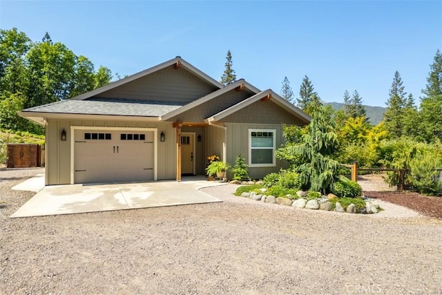 9116 Rocky Rd, Weed, CA 96094 - view of front facade featuring concrete driveway, board and batten siding, a garage, and roof with shingles
