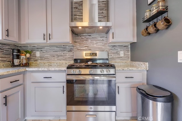 2846 Nandina Dr, Palmdale, CA 93550 - kitchen with gas range, wall chimney range hood, tasteful backsplash, and white cabinetry