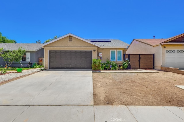 2846 Nandina Dr, Palmdale, CA 93550 - ranch-style home with stucco siding, a garage, solar panels, driveway, and a gate