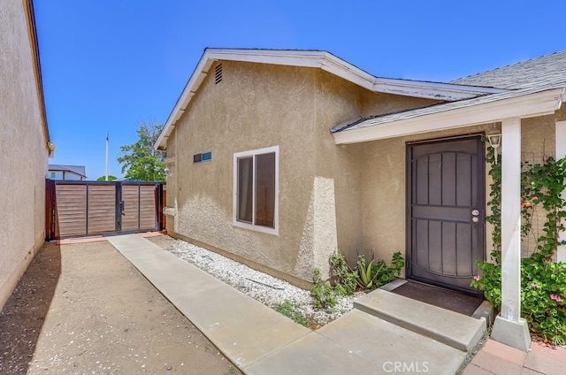2846 Nandina Dr, Palmdale, CA 93550 - doorway to property with stucco siding and a gate