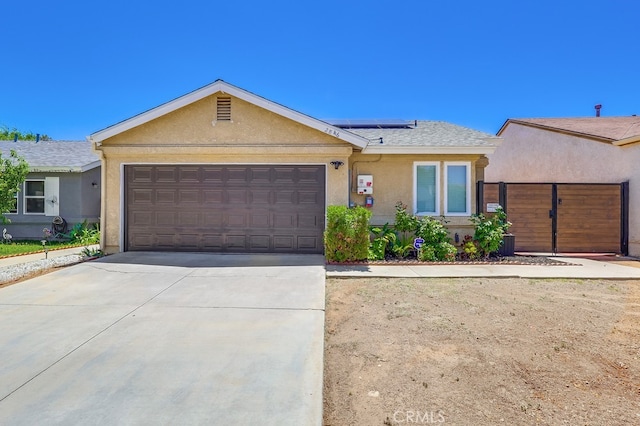 2846 Nandina Dr, Palmdale, CA 93550 - ranch-style home with stucco siding, an attached garage, driveway, and solar panels