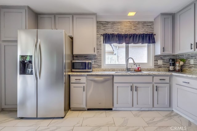 2846 Nandina Dr, Palmdale, CA 93550 - kitchen featuring stainless steel appliances, a sink, light marble finish floors, gray cabinets, and tasteful backsplash
