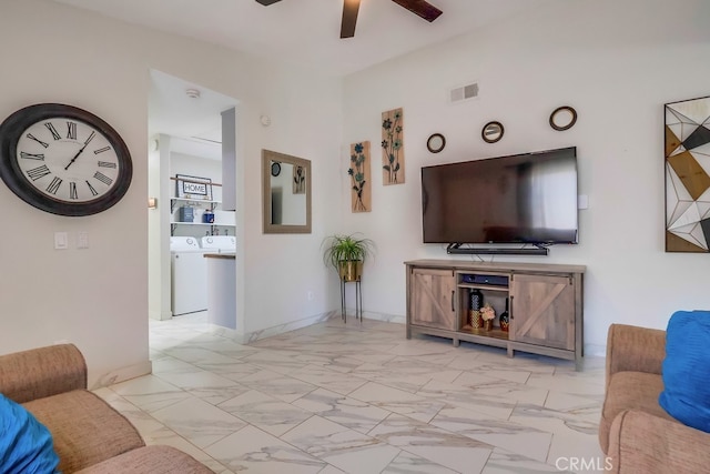 2846 Nandina Dr, Palmdale, CA 93550 - living area with ceiling fan, light marble finish flooring, baseboards, and separate washer and dryer