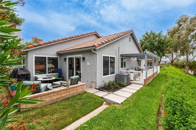 27705 Calle Valdes, Mission Viejo, CA 92692 - back of house featuring stucco siding, a pergola, a patio area, a tile roof, and a lawn
