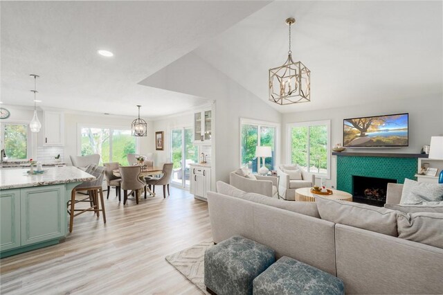 27705 Calle Valdes, Mission Viejo, CA 92692 - living room featuring a chandelier, light wood finished floors, a tiled fireplace, recessed lighting, and lofted ceiling