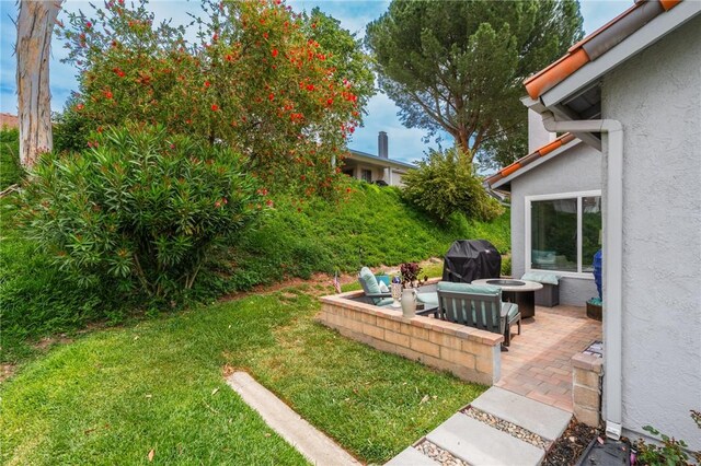 27705 Calle Valdes, Mission Viejo, CA 92692 - view of green lawn featuring a fire pit and a patio
