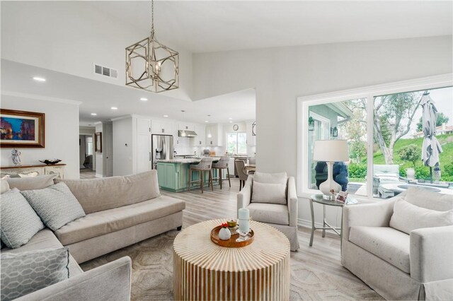 27705 Calle Valdes, Mission Viejo, CA 92692 - living area with a chandelier, recessed lighting, high vaulted ceiling, and light wood-type flooring