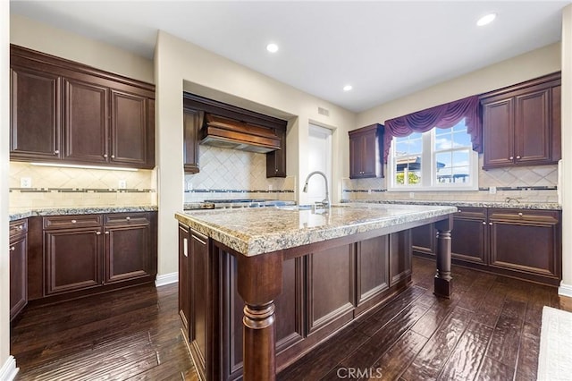 19599 Highland Terrace Dr, Walnut, CA 91789 - kitchen featuring decorative backsplash, dark wood-style flooring, a center island with sink, a sink, and recessed lighting