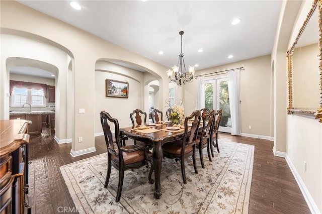 19599 Highland Terrace Dr, Walnut, CA 91789 - dining area featuring a chandelier, dark wood-style floors, arched walkways, recessed lighting, and baseboards