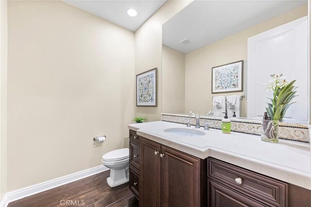 19599 Highland Terrace Dr, Walnut, CA 91789 - bathroom featuring baseboards, wood finished floors, toilet, and vanity