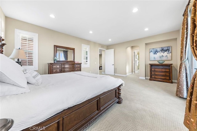 19599 Highland Terrace Dr, Walnut, CA 91789 - bedroom featuring arched walkways, light carpet, recessed lighting, baseboards, and multiple windows