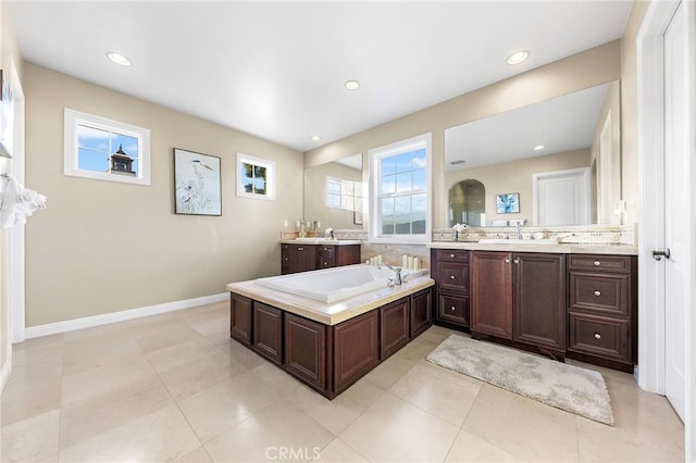 19599 Highland Terrace Dr, Walnut, CA 91789 - bathroom with two vanities, a garden tub, recessed lighting, baseboards, and tile patterned floors