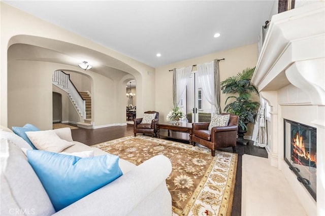 19599 Highland Terrace Dr, Walnut, CA 91789 - living room featuring arched walkways, stairs, a glass covered fireplace, recessed lighting, and wood finished floors