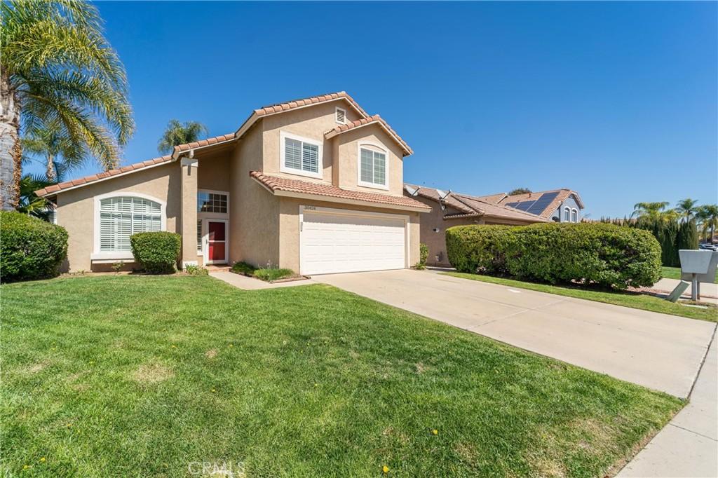 30424 Bogart Pl, Temecula, CA 92591 - view of front of property with stucco siding, an attached garage, driveway, a front yard, and a tile roof