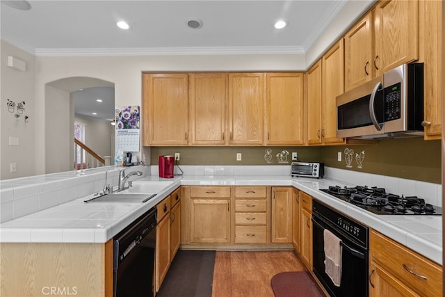 25562 Fitzgerald Ave, Stevenson Ranch, CA 91381 - kitchen featuring black appliances, a peninsula, tile countertops, ornamental molding, and wood finished floors