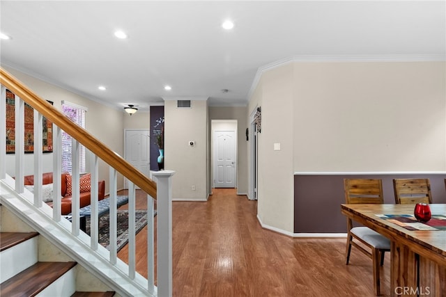 25562 Fitzgerald Ave, Stevenson Ranch, CA 91381 - hallway featuring ornamental molding, stairs, wood finished floors, and recessed lighting