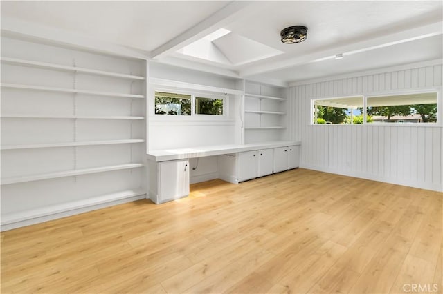 4561 N Price Ave, Fresno, CA 93726 - unfurnished room with a skylight, light wood-style flooring, built in shelves, and beam ceiling