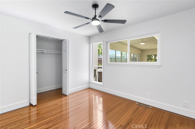 4561 N Price Ave, Fresno, CA 93726 - unfurnished bedroom with baseboards, wood finished floors, a closet, and a ceiling fan