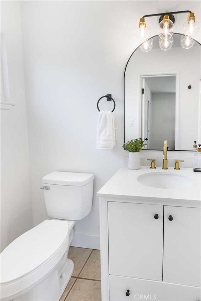 4561 N Price Ave, Fresno, CA 93726 - half bathroom featuring toilet, vanity, and tile patterned flooring